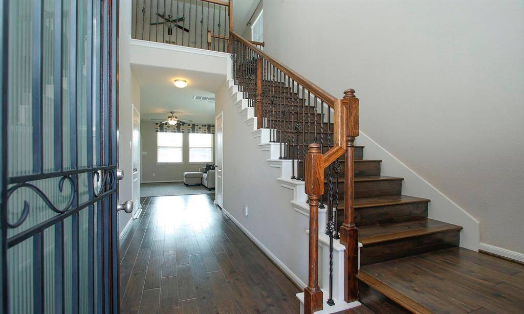 Stepping inside this former model home you will be impressed with the openness and high ceilings.