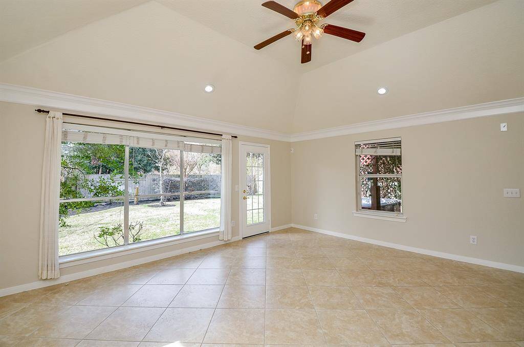 Large windows overlooking the backyard in the living room.