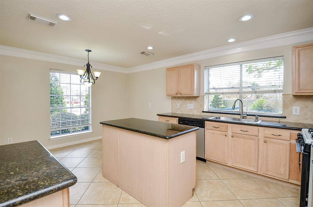 Kitchen features granite countertops and center island.