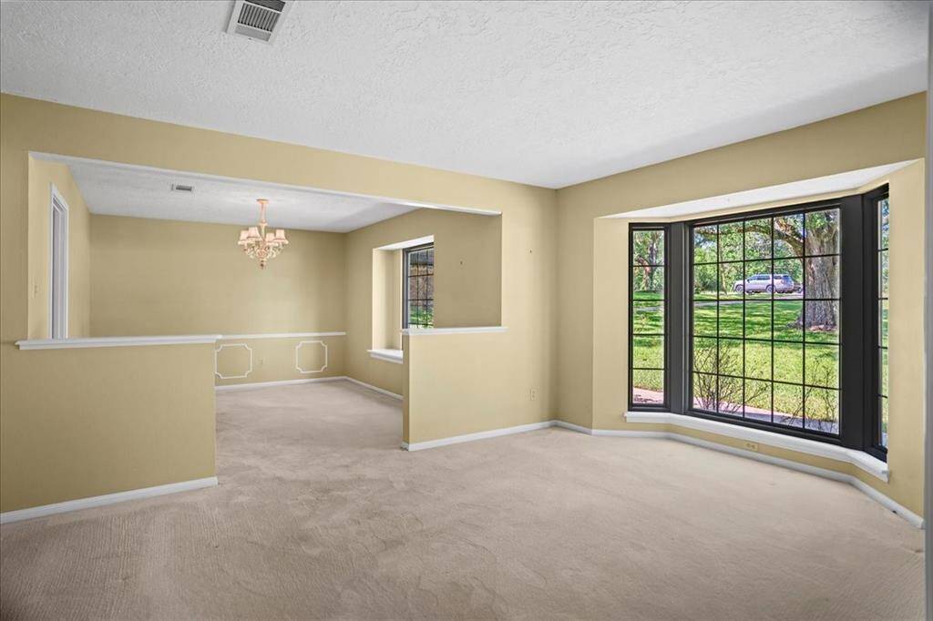 Formal living with with large window and dining room