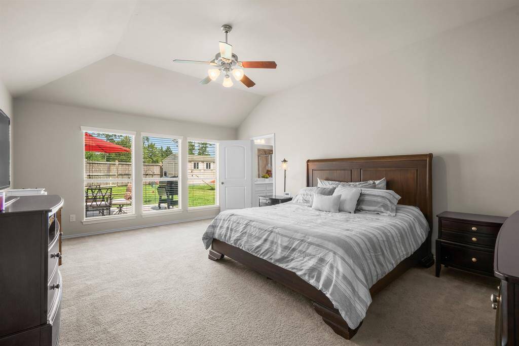 Tucked away at the back of the home, the oversized primary bedroom features vaulted ceilings that add to the spacious feel, creating a peaceful and airy retreat to unwind at the end of the day.