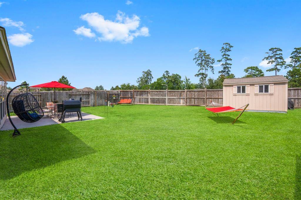 This expansive backyard is ready for weekend fun or evening relaxation; with space to entertain, garden, or simply unwind.