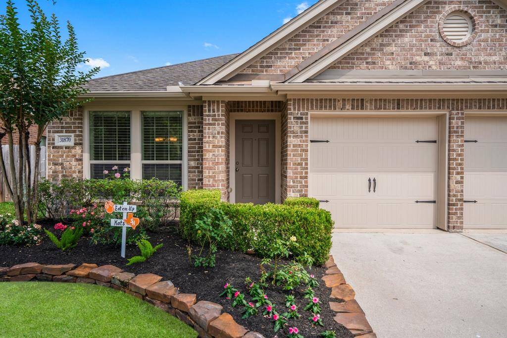 This closer view highlights the home’s fresh exterior paint and crisp curb appeal, complemented by recently updated landscaping that adds vibrant color and a welcoming first impression.
