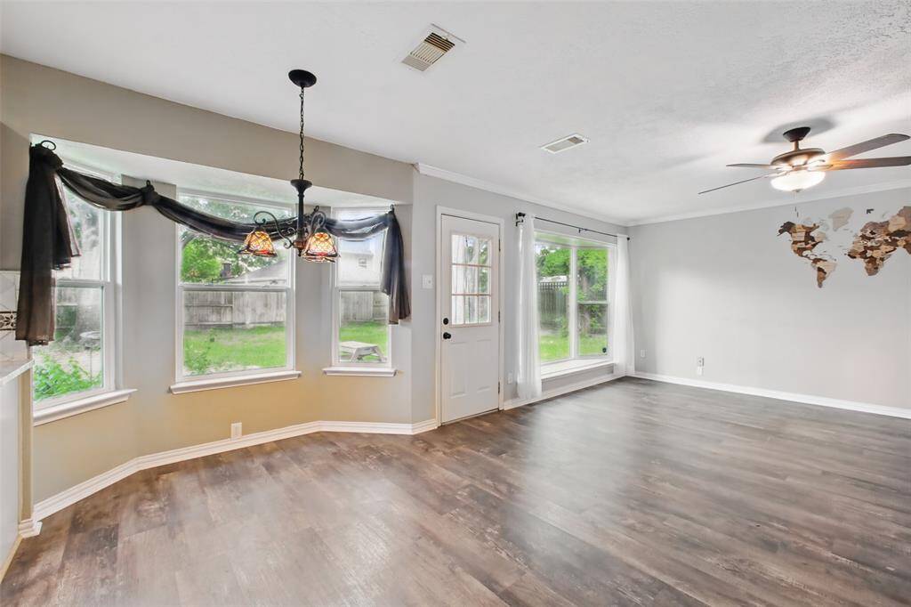 Breakfast room with bay window feature offers serene views of the backyard.