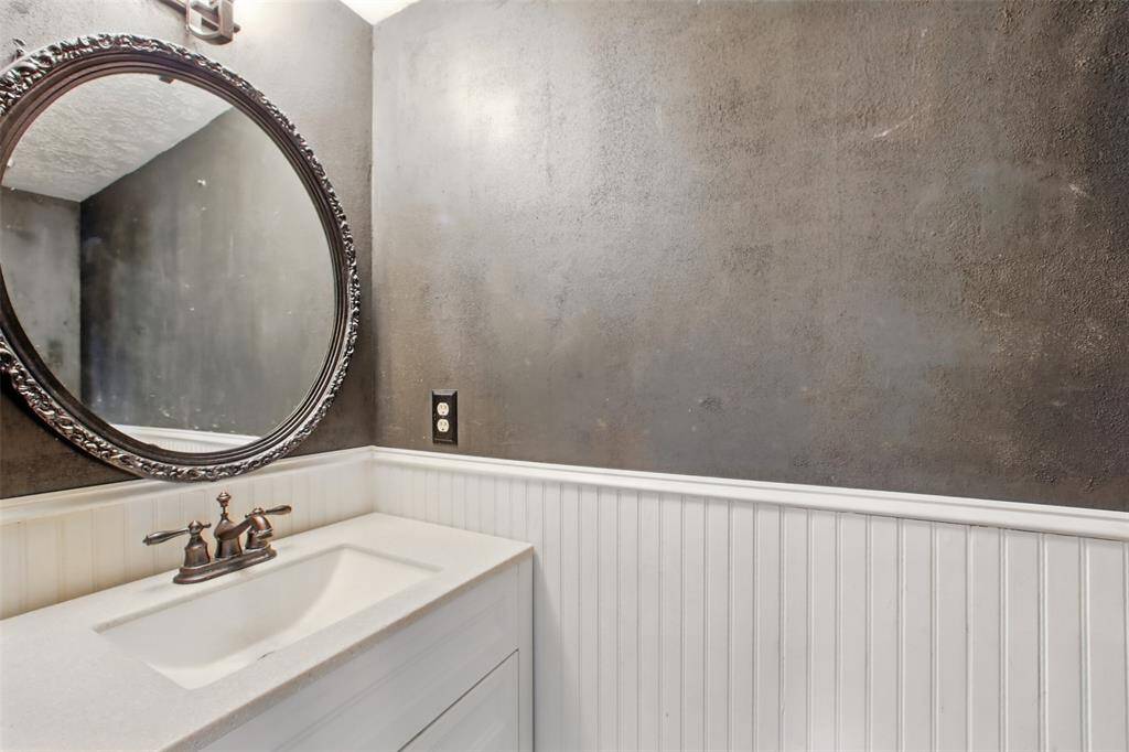 Convenient downstairs half bath with updated vanity and beadboard detail.