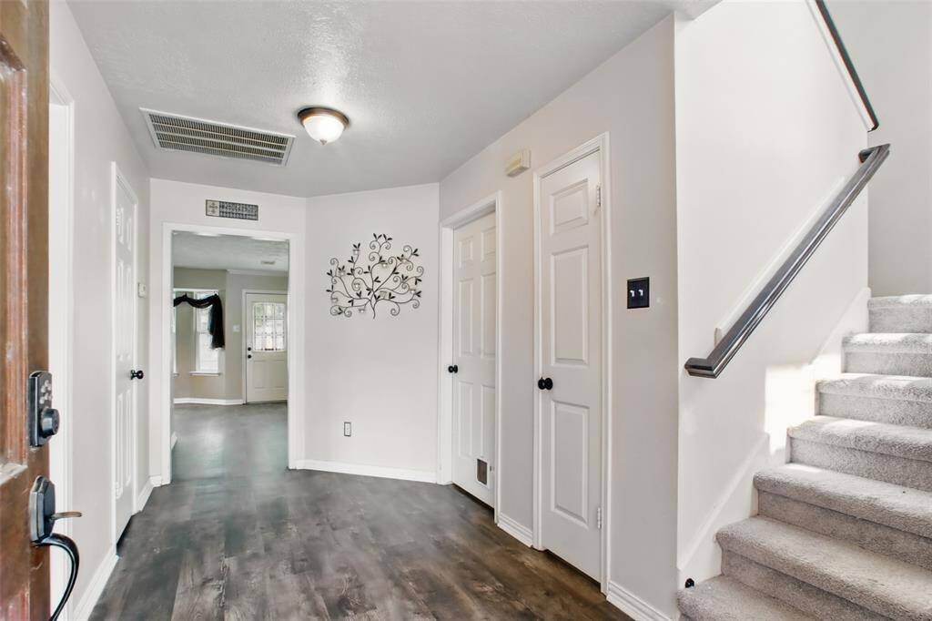 Welcoming entryway with stylish vinyl plank flooring.