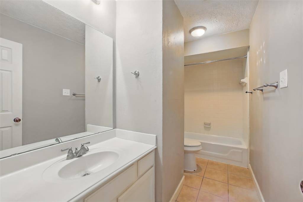 Shared hall bath for the secondary bedrooms with tub/shower combination.