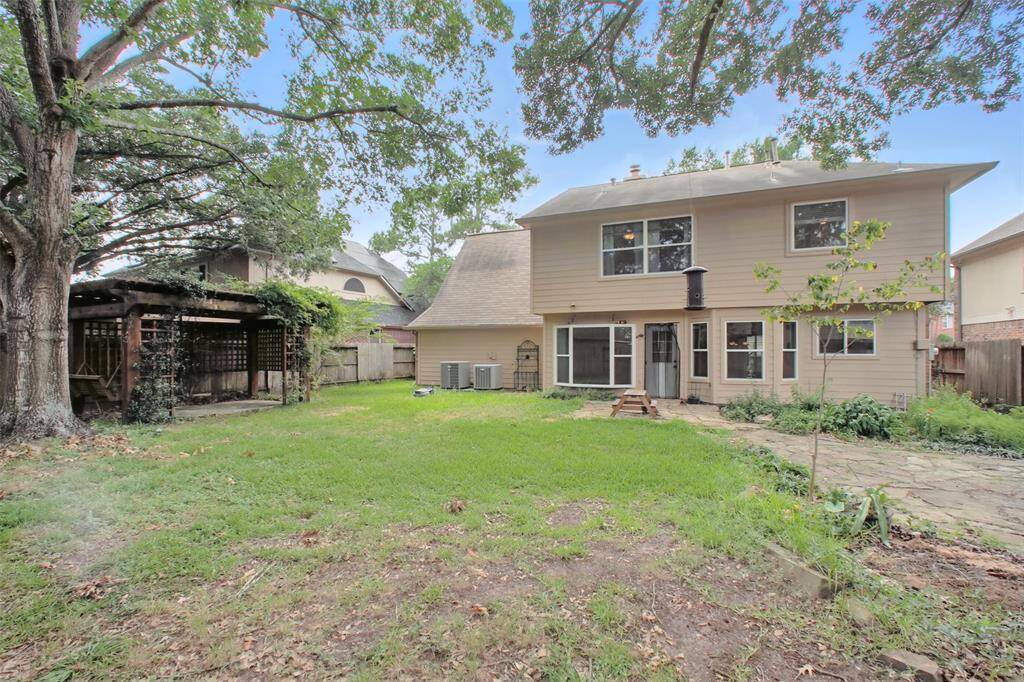 This backyard features several gathering areas. Notice the paver space, perfect for an outdoor fire pit.