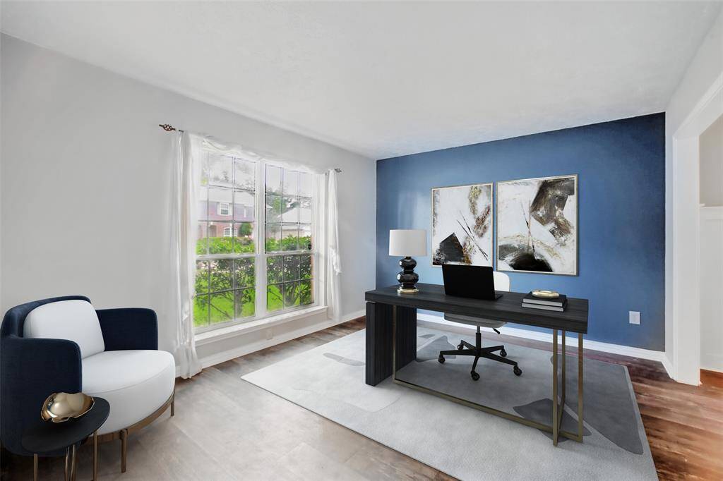 To the left of the entry way is the formal living room. This versatile space can be used as a home office, play area or sitting room. Photo is virtually staged.