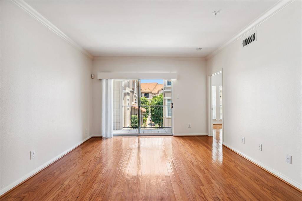 Generously sized living area with warm hardwood floors, perfect for relaxing or hosting friends.