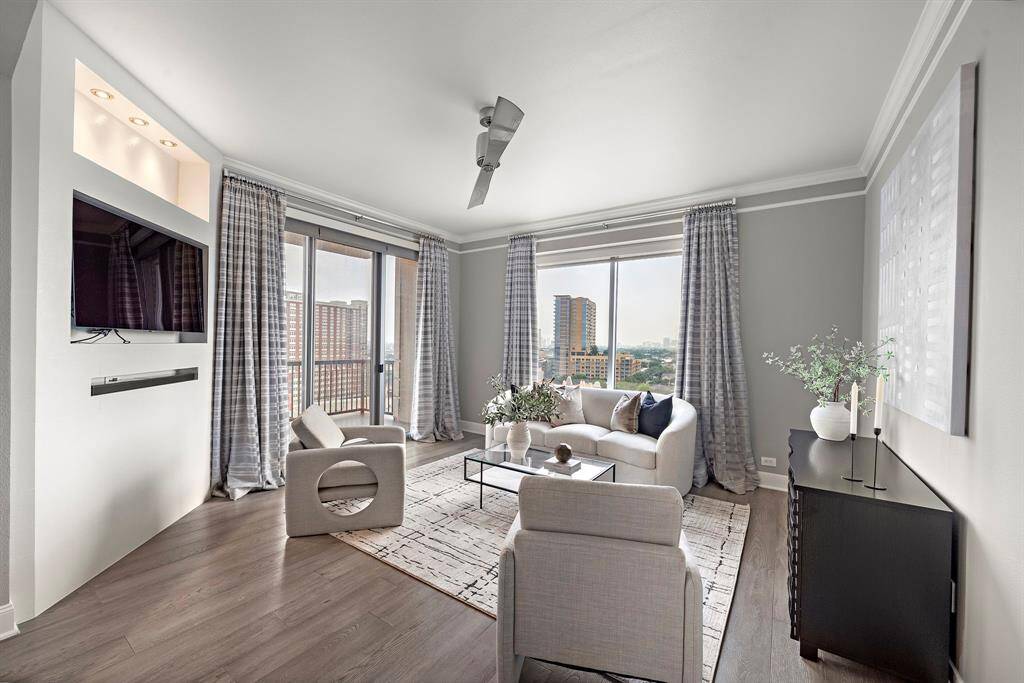 Tall windows stretch across the walls, framing elevated views of the city while welcoming an abundance of daylight into the main gathering space.