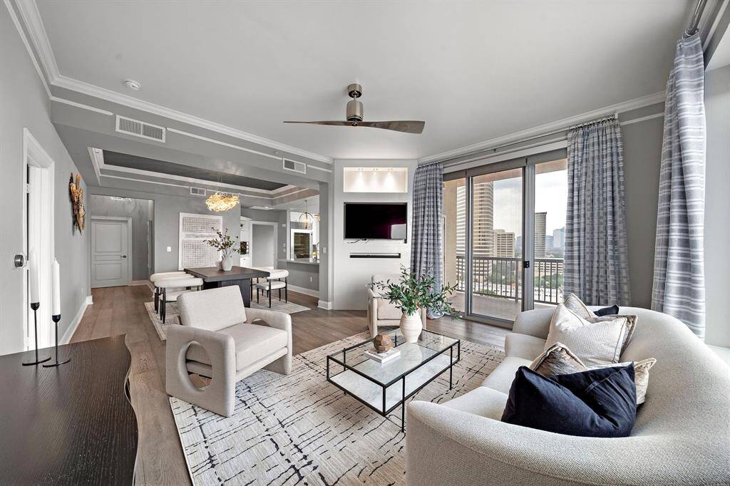 This corner living space subtly pivots toward the dining area, enhancing its sense of orientation while capturing southwest-facing city views.