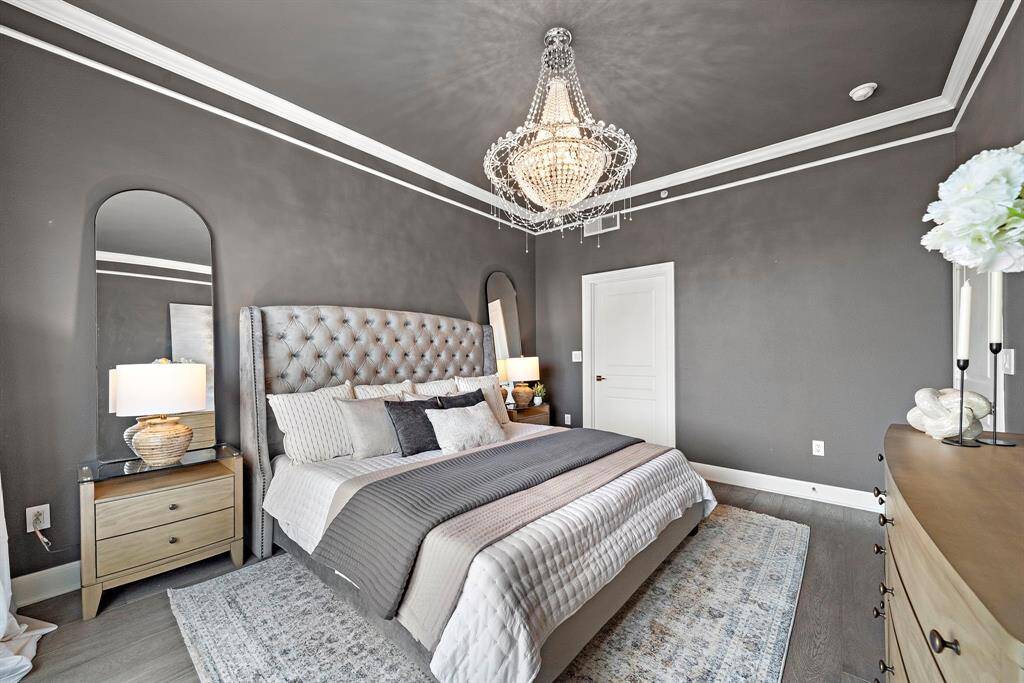Introduced through a wide entry, the primary bedroom offers balanced proportions and clean architectural detailing, ideal for tailoring the space to any lifestyle.