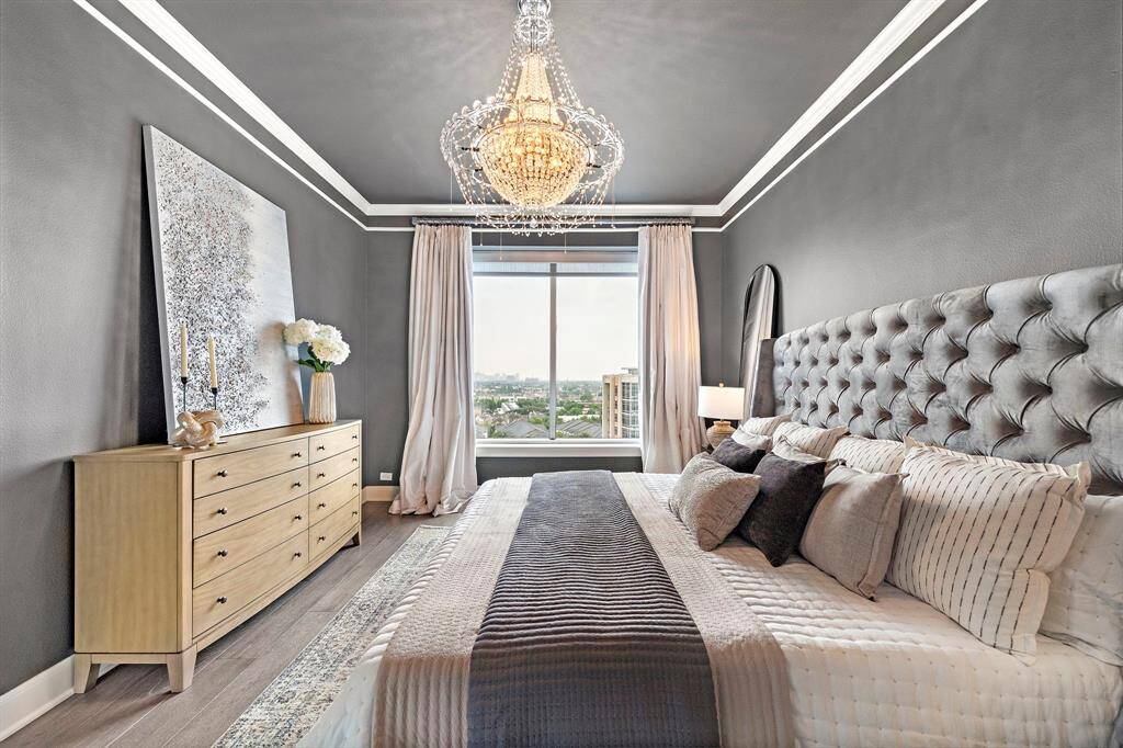 Light spills across the hardwoods from multiple angles, while the layout preserves generous wallspace for flexible placement of seating or storage.