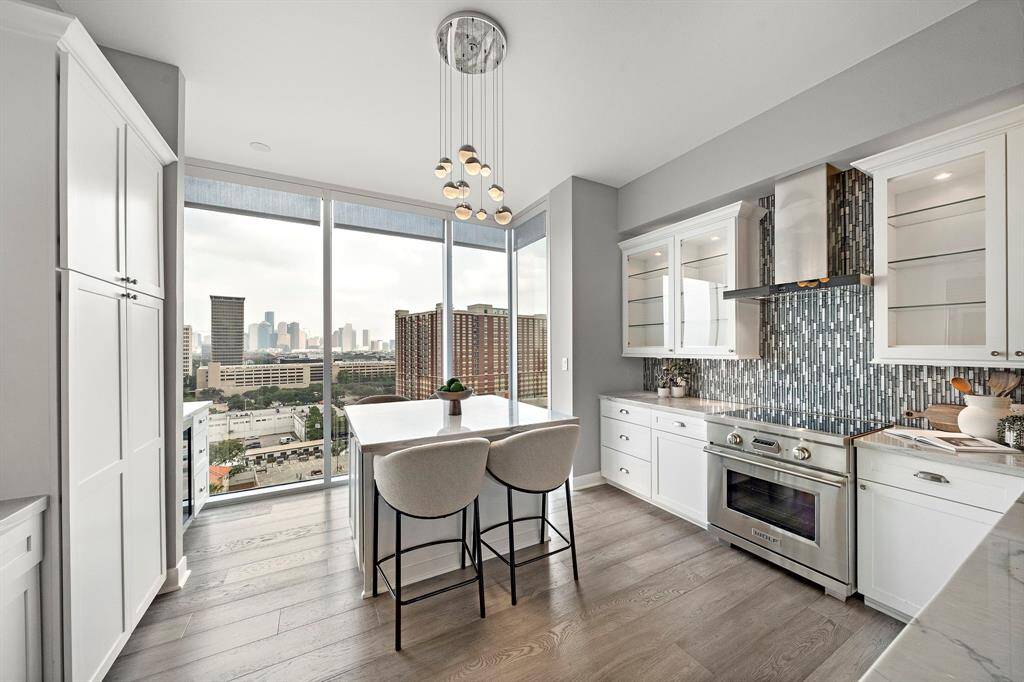 The updated kitchen blends function and elegance with quartz counters, sleek cabinetry, and premium stainless appliances. A breakfast bar and wine bar complete the design, making it ideal for casual mornings or evening gatherings.