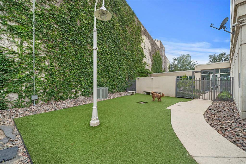 A fully enclosed dog run features artificial turf, gated access, and a private corner of the grounds designed just for residents and their pets.