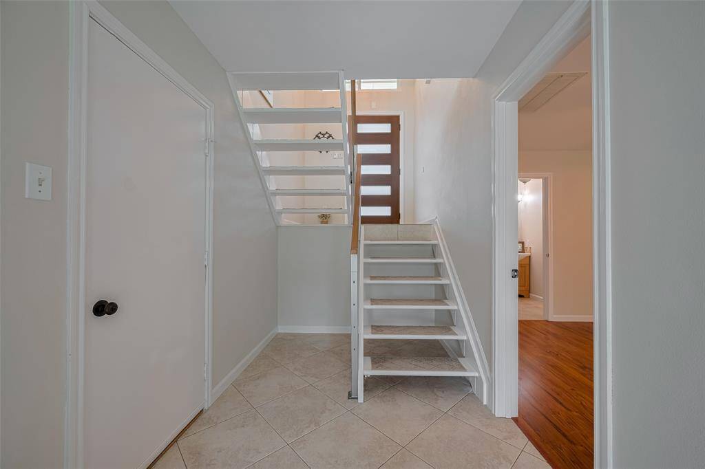 This is downstairs with the garage to the left and the primary bedroom on the right.  This view is taken from the back of the house facing the front door.