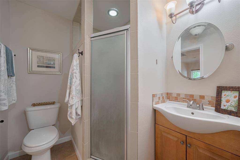 The primary bathroom has a corner shower and single vanity.