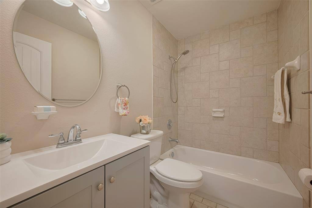 The Upstairs bathroom has a large single vanity and tub shower area.