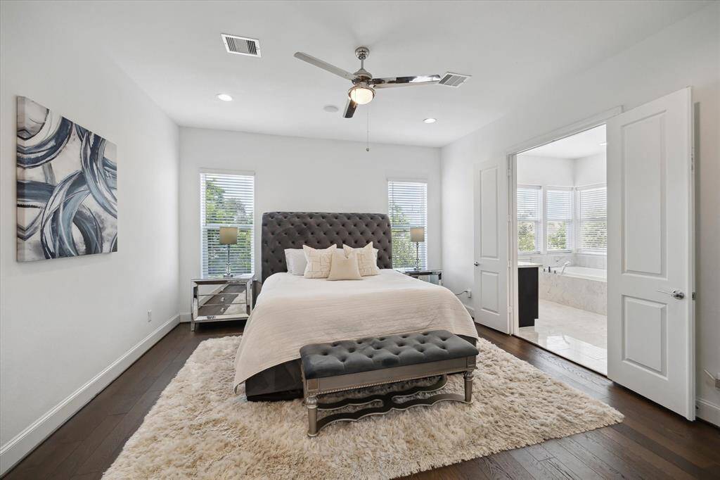 Retreat to the serene and spacious primary bedroom, filled with natural light and offering direct access to the luxurious en-suite bath.