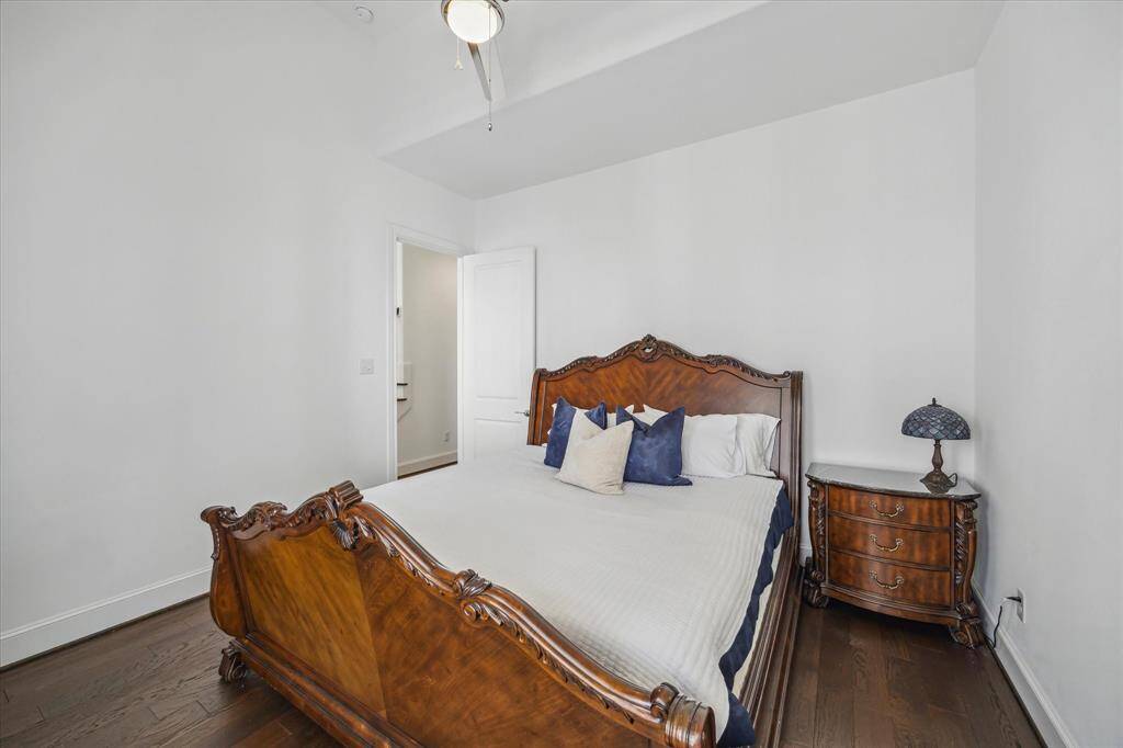 This inviting second-floor bedroom boasts elegant hardwood floors, a generous layout, and a walk-in closet—perfect for comfort and functionality.
