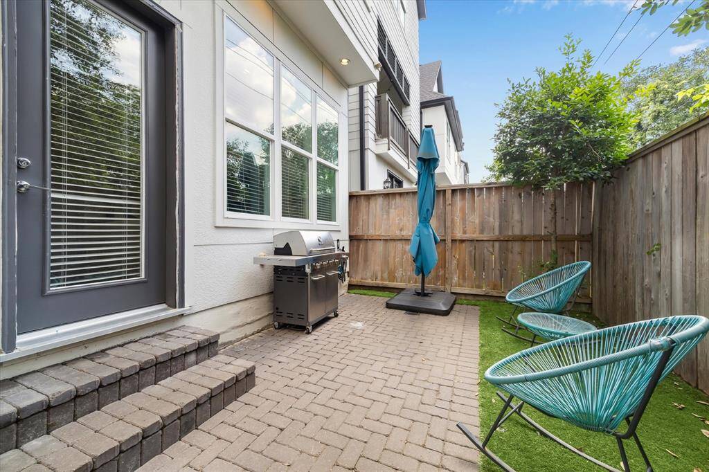 Step out into a cozy backyard retreat featuring low-maintenance turf and a paved patio—perfect for grilling, lounging, and dining al fresco.
