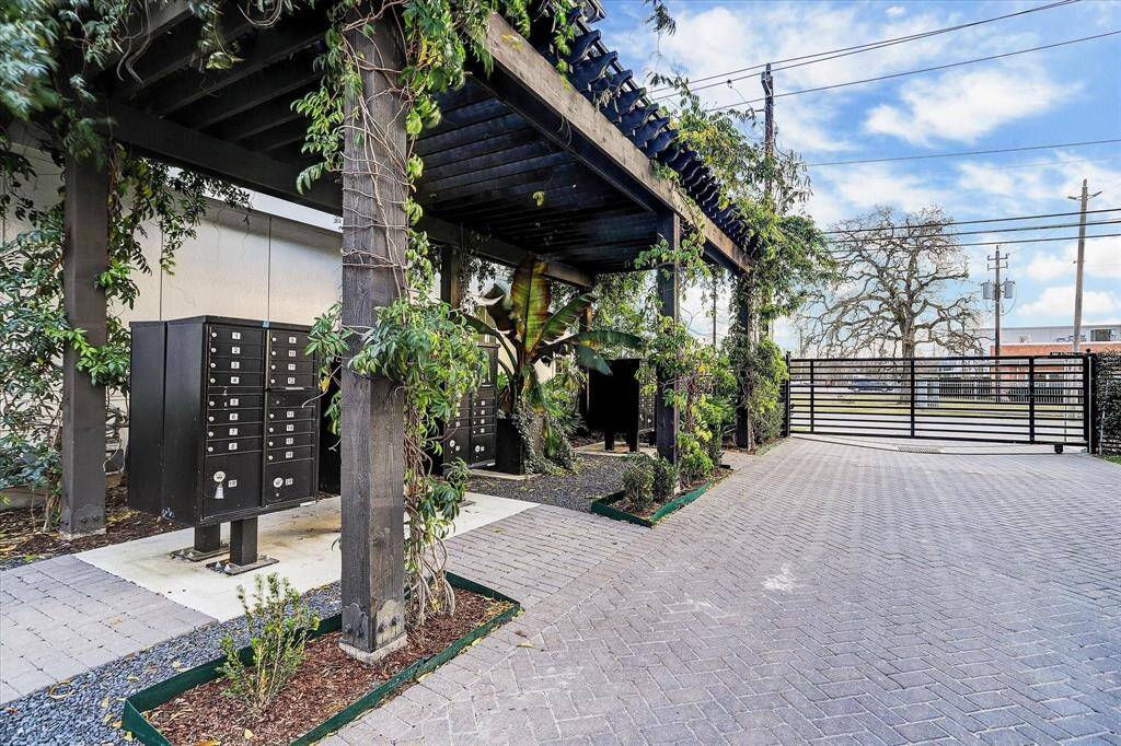 Convenient and secure, the community mail center is tucked under a lush, vine-covered pergola near the gated entry—blending function with thoughtful, stylish design.