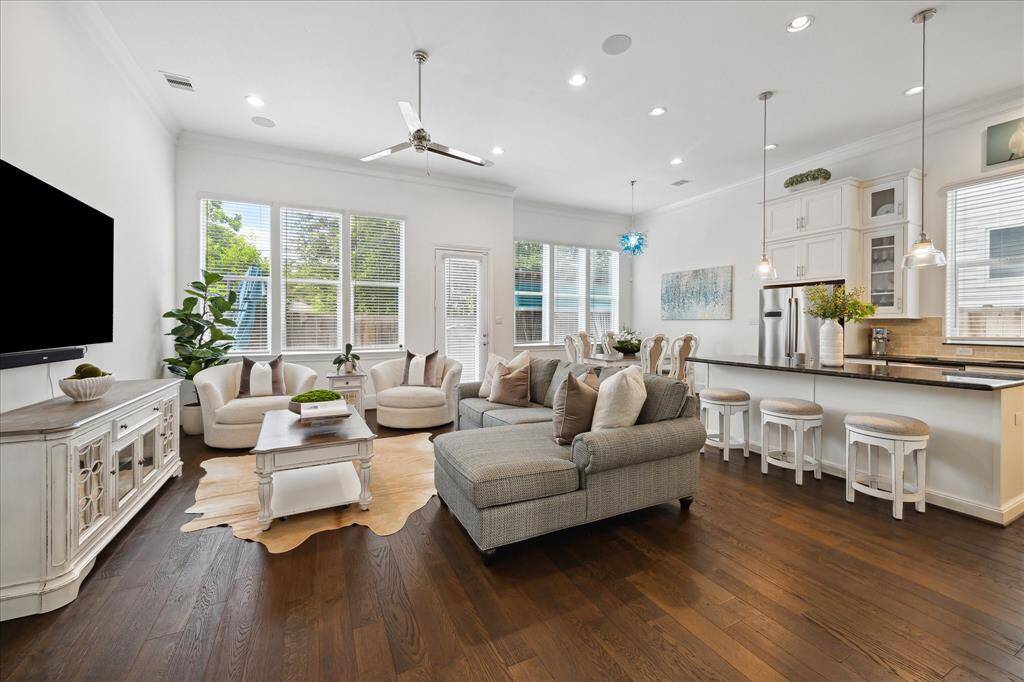 This bright and spacious first-floor living area welcomes you with rich hardwood floors, abundant natural light, and seamless flow into the kitchen and dining—perfect for everyday living and entertaining.