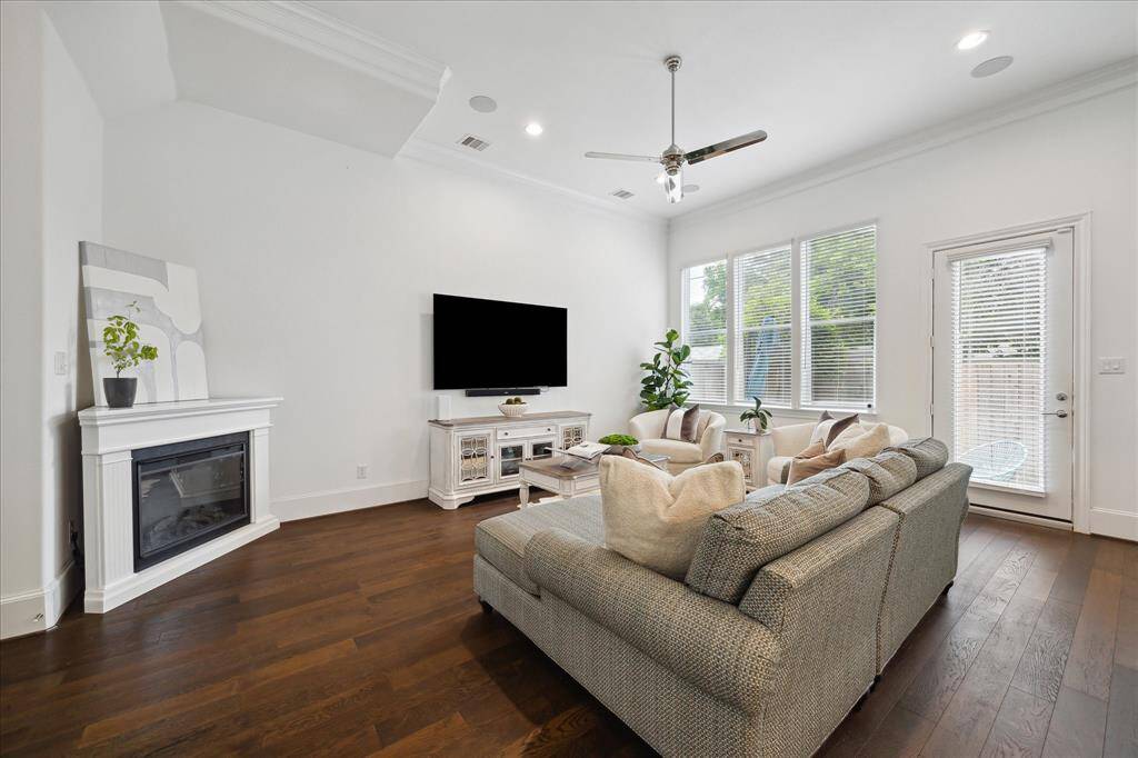 Enjoy cozy evenings in or step outside to the backyard oasis—this inviting living space offers the best of indoor-outdoor living, enhanced by built-in surround sound speakers in the living room, primary bedroom, third floor, and backyard.
