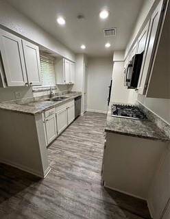 Kitchen with GRANITE countertops and Stainless Steel Appliances