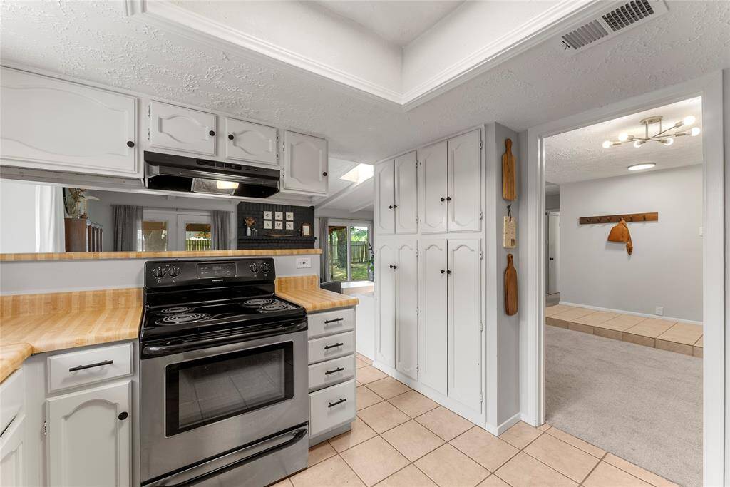 The kitchen has two entries that lead to either the formal dining or living area.