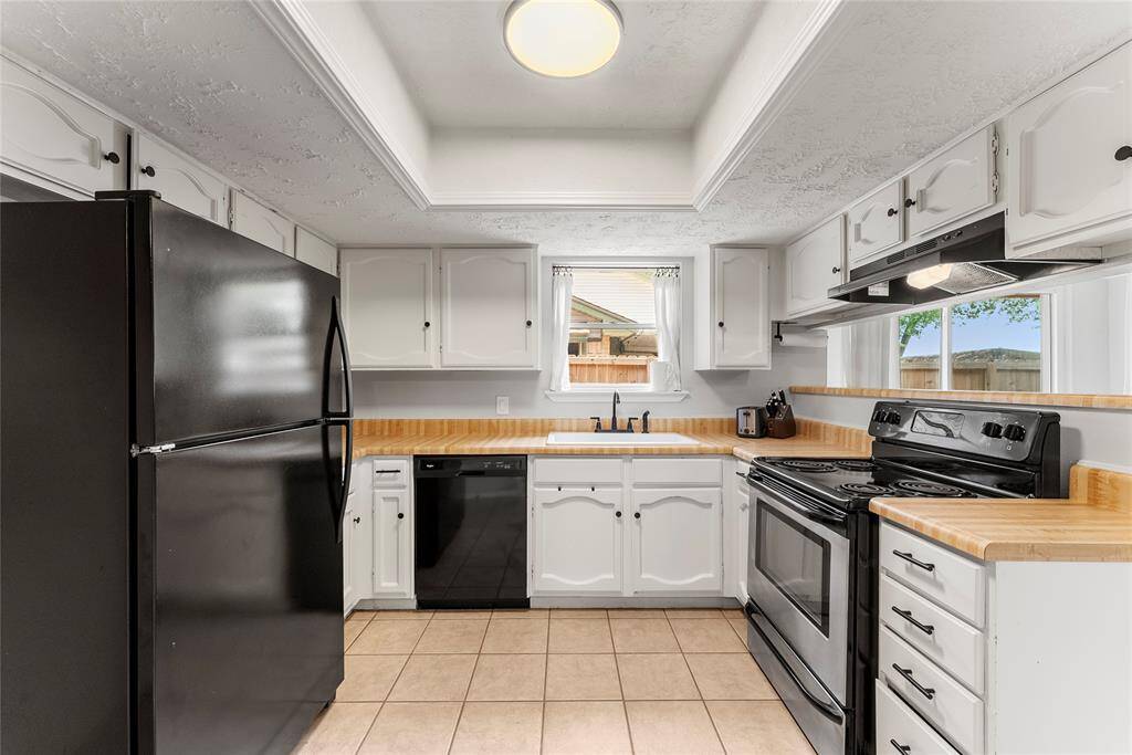 Nice kitchen with plenty of counter space and a view out the window or towards the breakfast area.