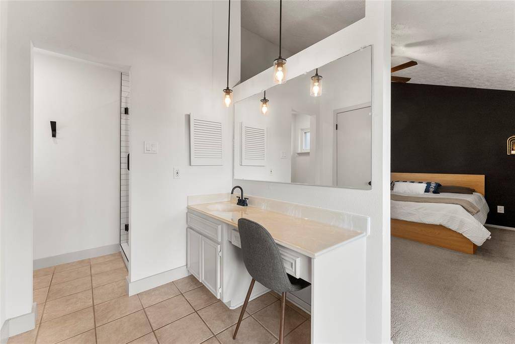 The Primary Bathroom with a vanity and tons of natural light.