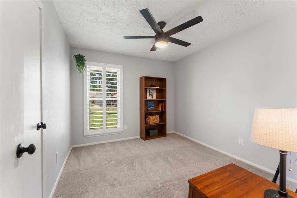 Second Bedroom featuring planation shutters, updated ceiling fans, and double paned windows.