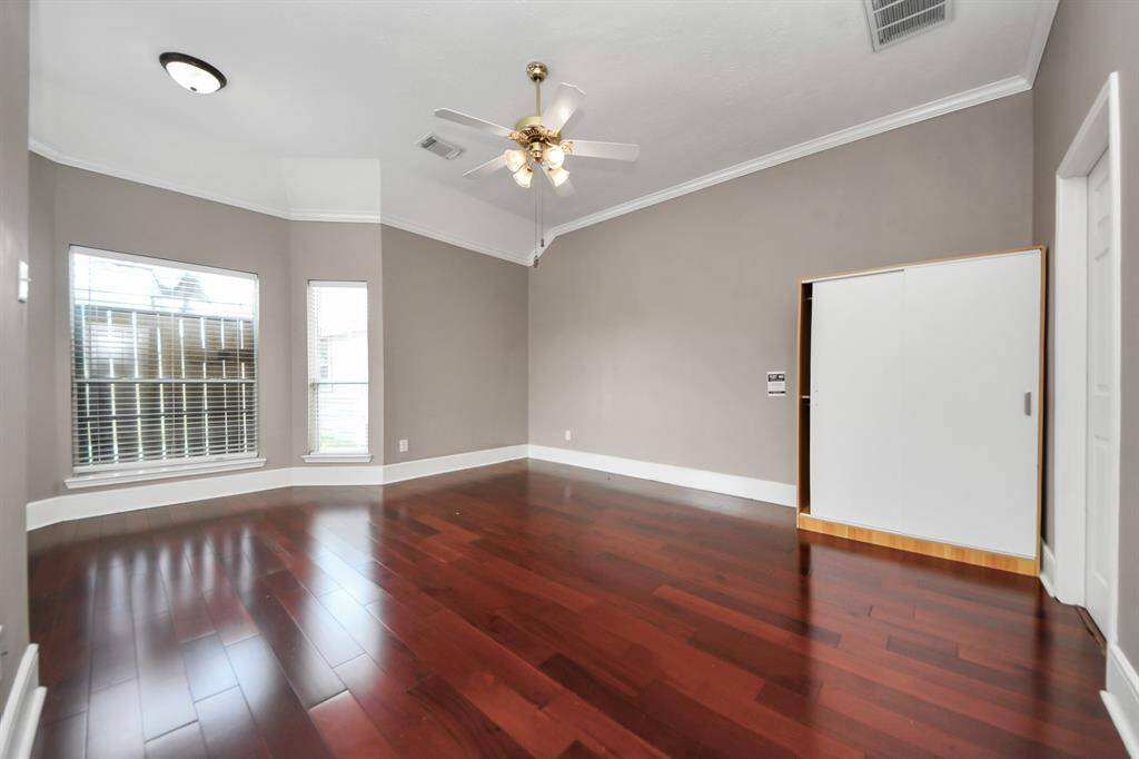 Master bedroom with wood floor