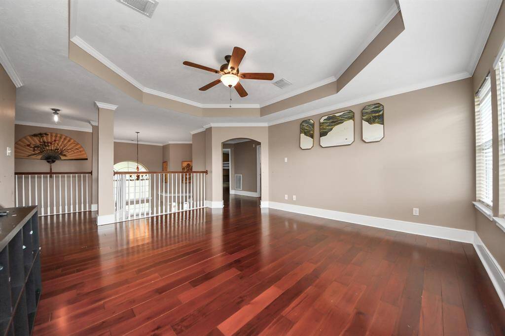 Game room with wood flooring