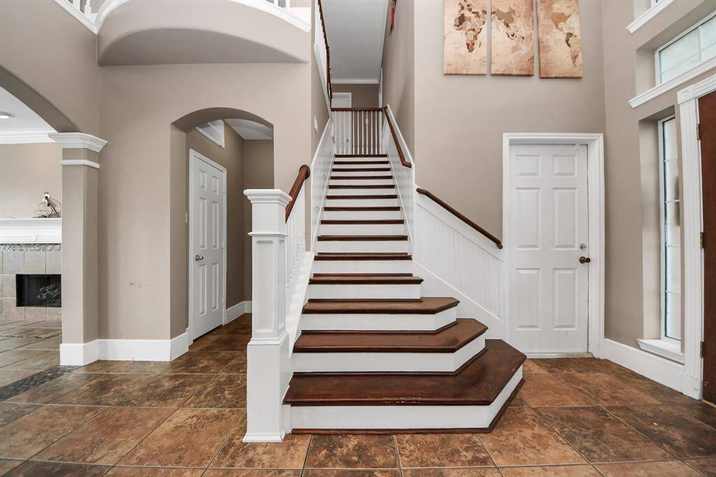 Stunning 2 story high ceiling entry with hard stained cherry solid oak floor steps.