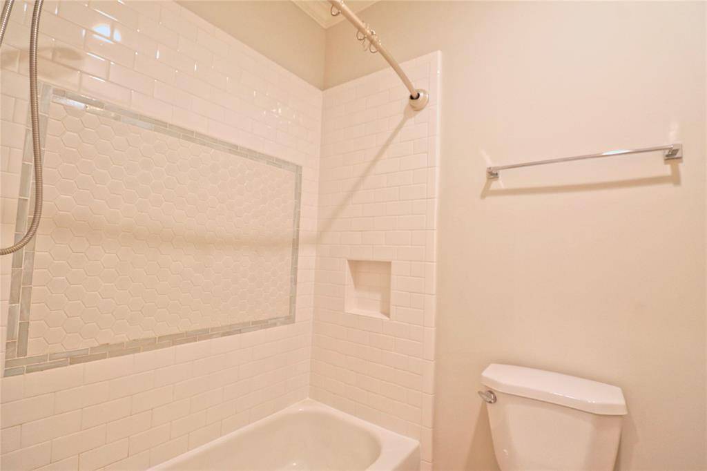 Secondary bathroom features elegant new shower wall and floor tiles.