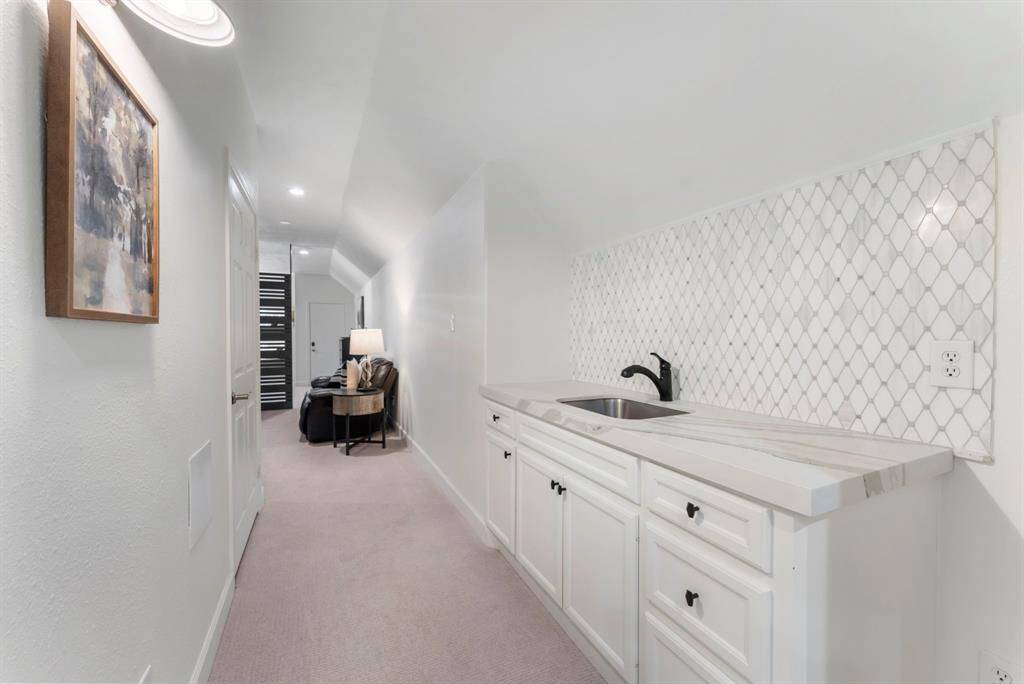 Walking into the media and game room with a wet bar.