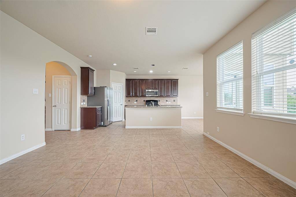 Bright and spacious open-concept living room—perfect for entertaining or relaxing in style, with effortless flow to the kitchen and dining areas.