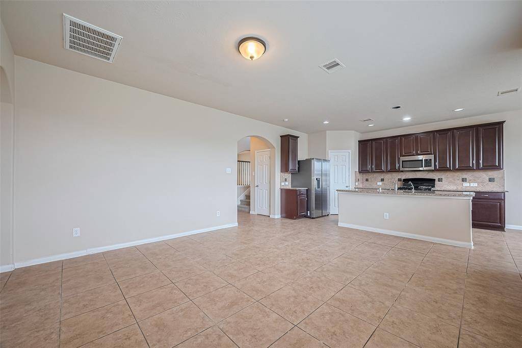 Enjoy a fully equipped kitchen with stainless steel appliances and a refrigerator included for your convenience.