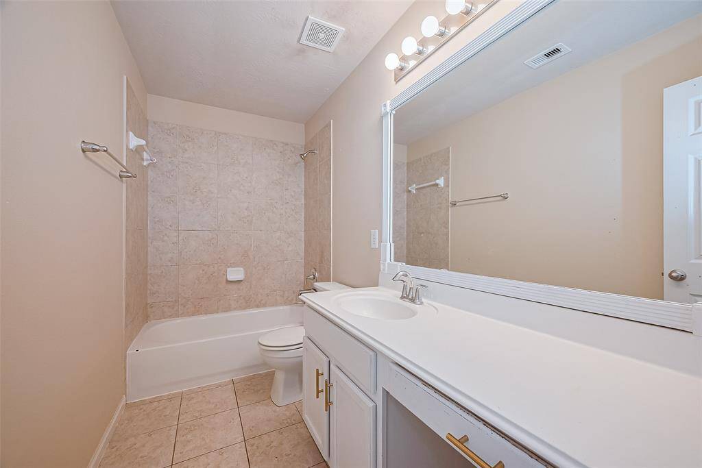 Spacious secondary bath with an extra-long vanity—perfect for shared use or added convenience.