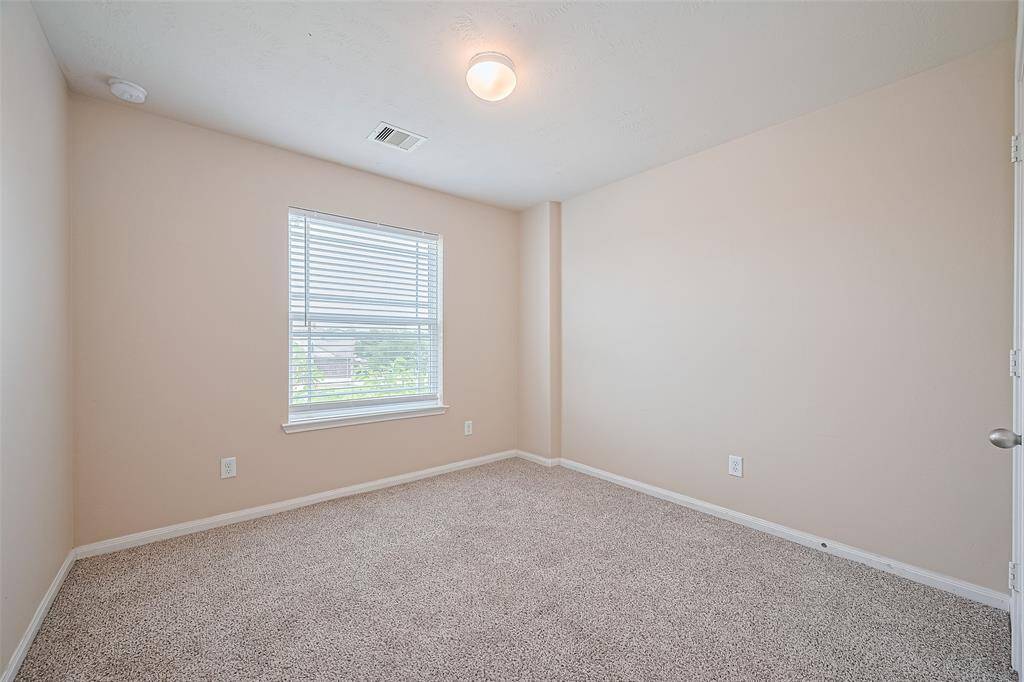 The extra bedroom is thoughtfully designed for versatility, whether as a guest suite, hobby room, or study.