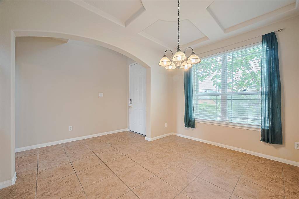 Graceful dining space near the entryway offers ample natural light and a warm, inviting atmosphere.