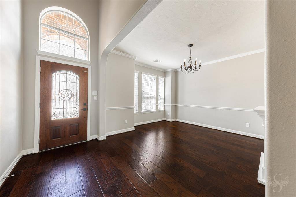 The elegance continues with wood floors flowing throughout the first floor, creating a warm and inviting ambiance.