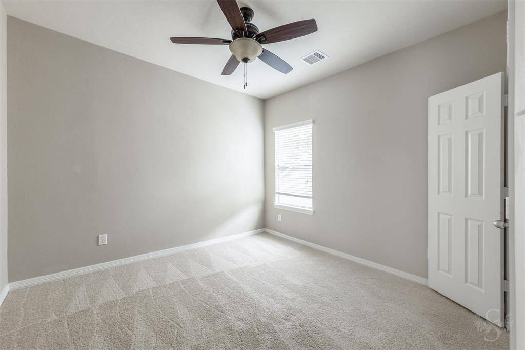 The secondary bedrooms on the second floor offer a perfect blend of comfort and functionality, each designed to provide a cozy retreat for family members or guests. As you step into these rooms, the plush carpet underfoot adds a layer of warmth and softness, enhancing the inviting ambiance.