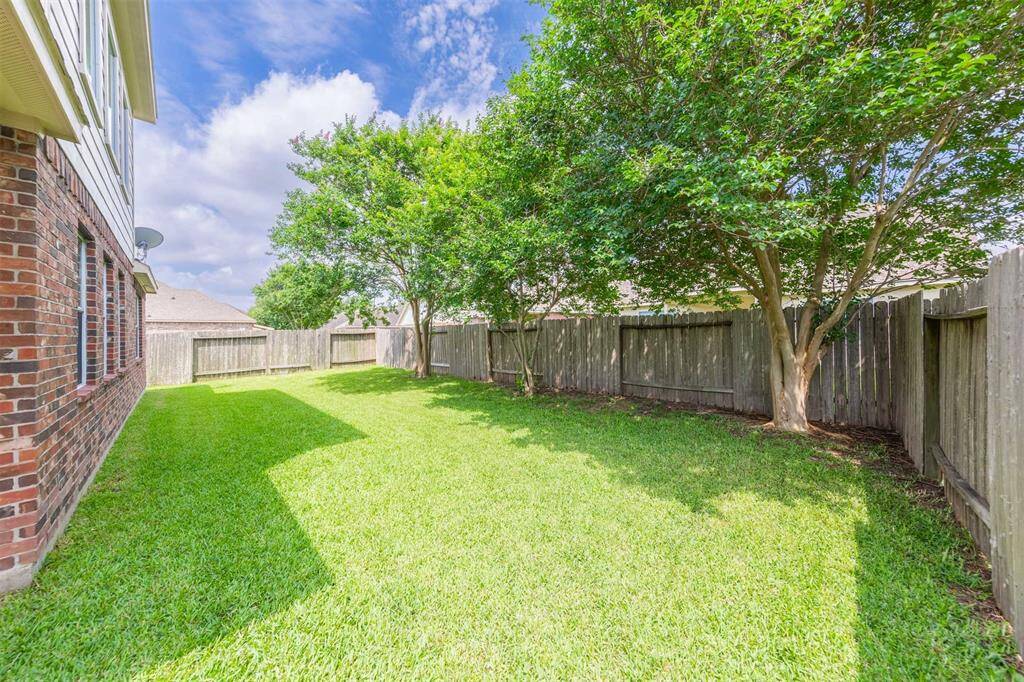 The patio is elegantly designed with a sturdy roof that offers protection from the elements, allowing for year-round enjoyment. Beneath the shelter, comfortable seating arrangements and a dining set create a versatile space ideal for gatherings with family and friends or quiet moments of solitude.