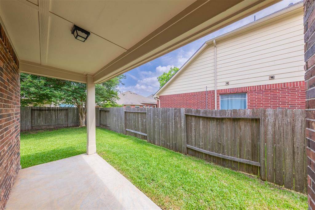 The patio is elegantly designed with a sturdy roof that offers protection from the elements, allowing for year-round enjoyment. Beneath the shelter, comfortable seating arrangements and a dining set create a versatile space ideal for gatherings with family and friends or quiet moments of solitude.