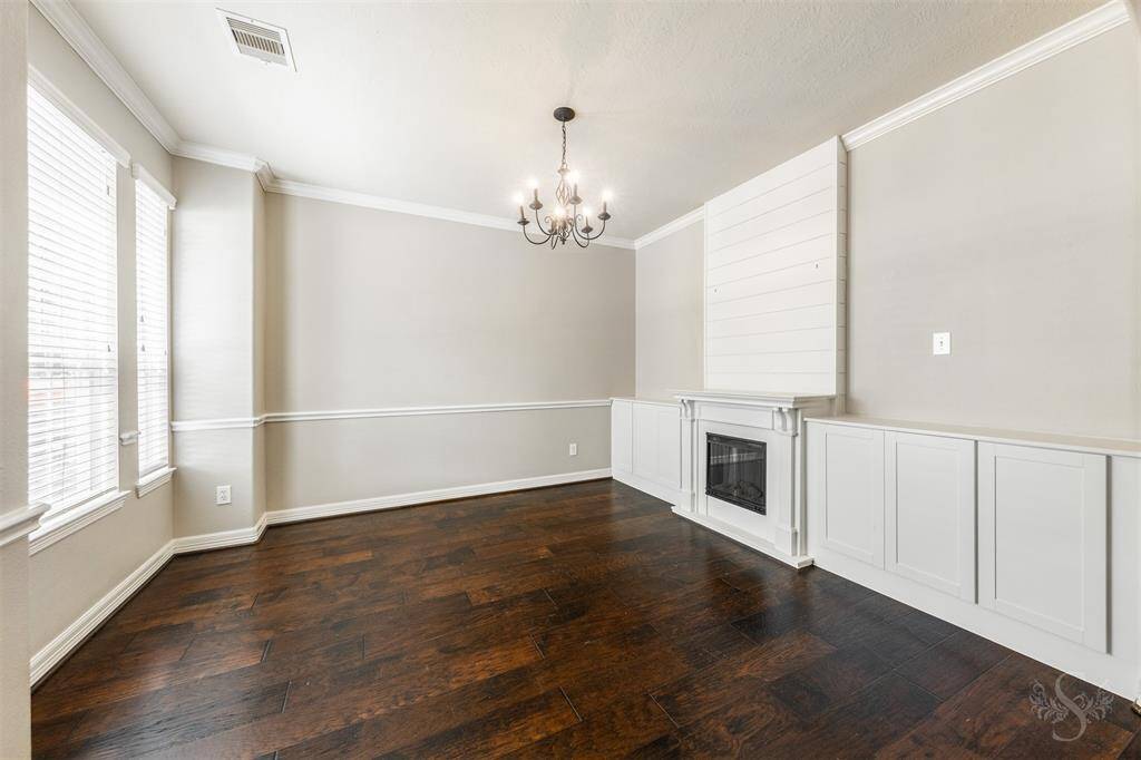 As you enter the front of the house, you are welcomed by the elegant dining room, a space that effortlessly combines functionality with style. Bathed in natural light from large front-facing windows, this room exudes a sense of openness and warmth.