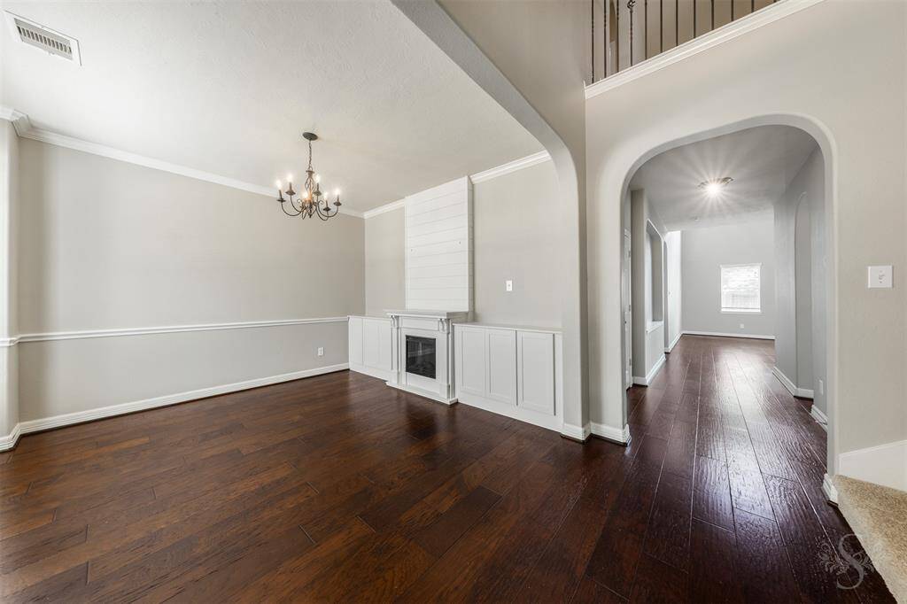 The dining room is graced with exquisite built-in cabinetry, offering both aesthetic appeal and practical storage solutions. These built-ins, crafted from fine wood, provide a perfect spot to display cherished china, glassware, or decorative pieces, adding a personalized touch to the room.